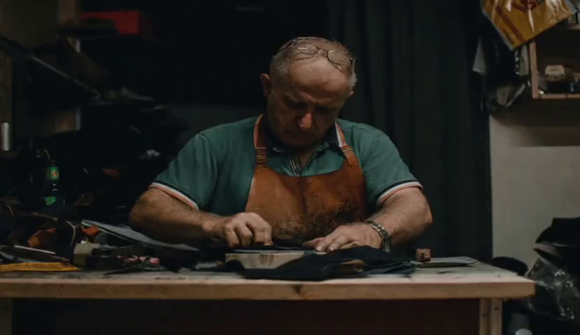 Reference image of a leather craftsman at his workbench