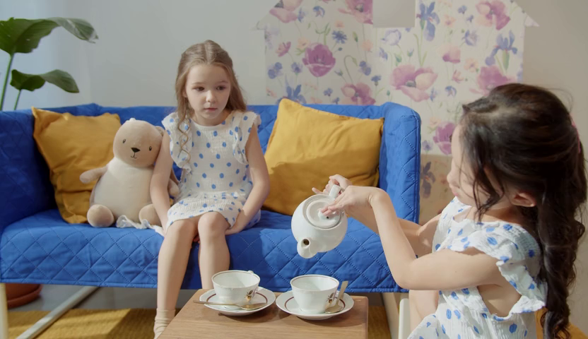 Reference image of two children at a tea party